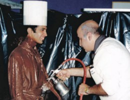 A street performing artist sprayed with chocolate surprised guests when he suddenly moved during a service.